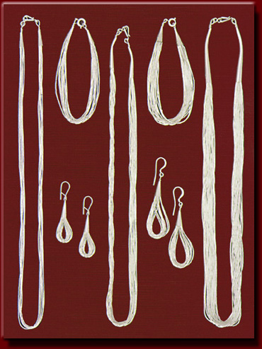 Long silver bead jewelry created into earrings, bracelets, and necklaces.