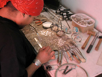 A Skystone Creations Native american indian jewelry silversmith's adds the finishing touches to one of our beautiful sterling silver jewelry and turquoise gemstone bracelets